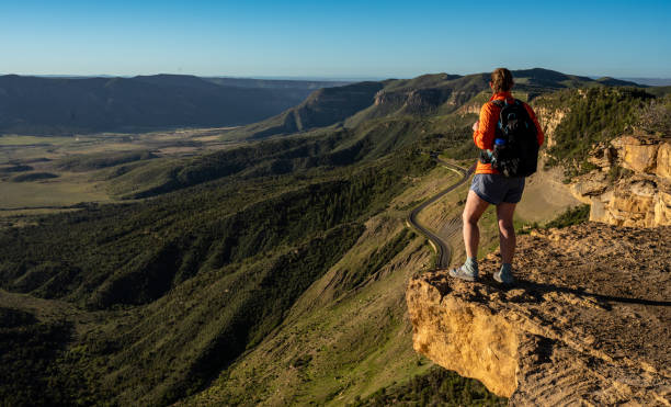 istock HIker Stands On Rock Shelf Looking Over Mesa Verde 1902974107