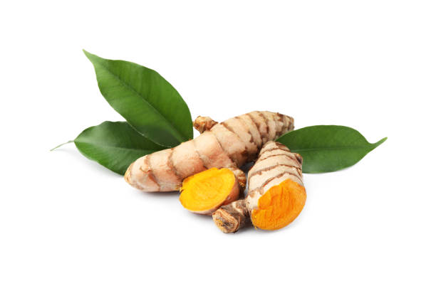 istock Fresh turmeric roots and green leaves isolated on white 1902975135