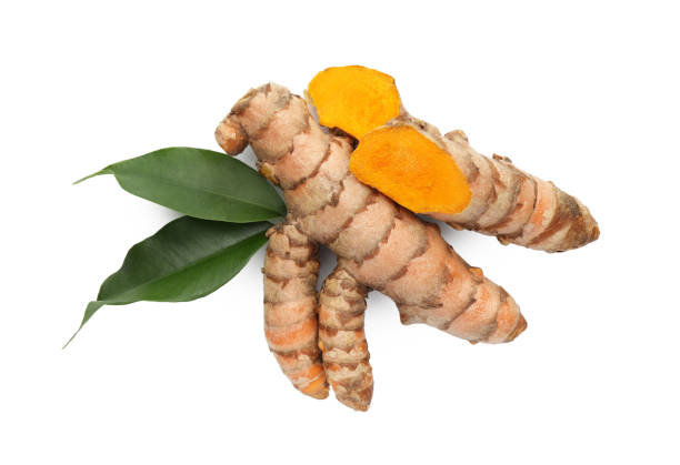 istock Fresh turmeric roots and green leaves isolated on white, top view 1902975654