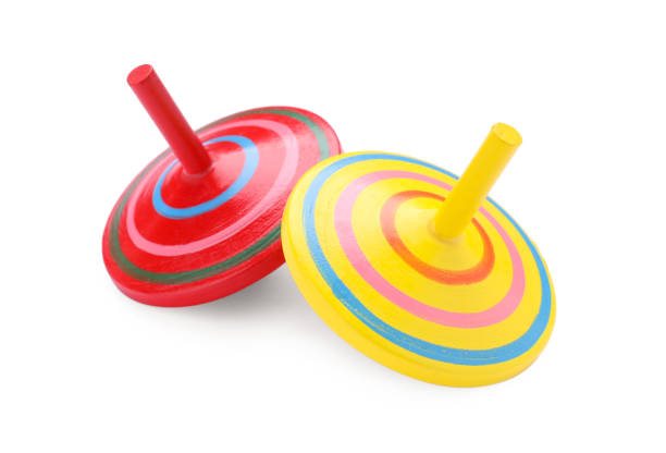 istock Two bright spinning tops isolated on white. Toy whirligig 1902989620