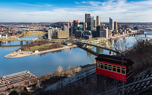 Pittsburgh, Pennsylvania, USA December 16, 2023 Downtown as seen from Mt Washington with a tram car from the Duquesne Incline on a sunny fall day