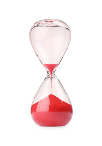 istock Hourglass with red flowing sand isolated on white 1902991730