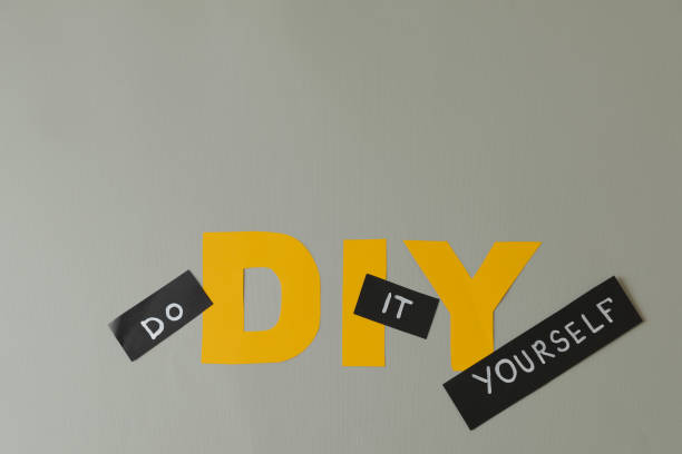 Phrase Do It Yourself and abbreviation DIY made of letters on light grey background, flat lay. Space for text