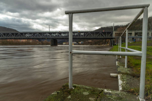 Flooded winter without snow river Labe with cloudy sky in Usti nad Labem