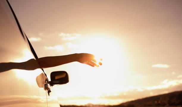 istock Woman enjoying beautiful sunset on a road trip. 1903068704