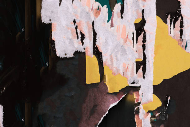 istock Pieces of torn paper peeling off wall used as billboard 1903082129