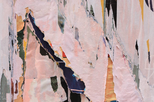 istock Pieces of torn paper peeling off wall used as billboard 1903082683