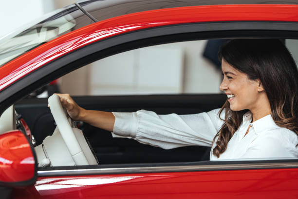 istock Young Woman Embracing Her New Car. 1903090017