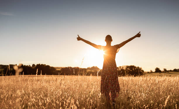 istock Happy young woman enjoying beautiful sunset. 1903129982