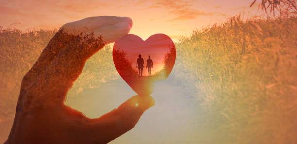 istock Man woman holding hands walking at sunset. 1903130506