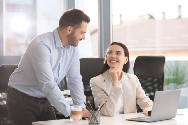istock Colleagues working on laptop at desk in office 1903149547