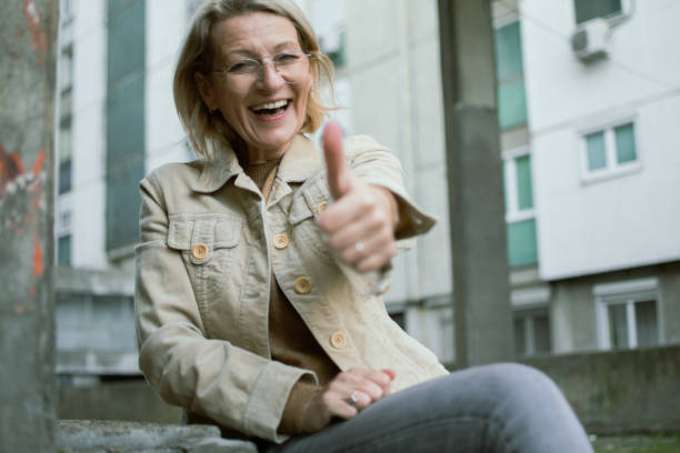 istock mature blonde woman sits outside 1903185820