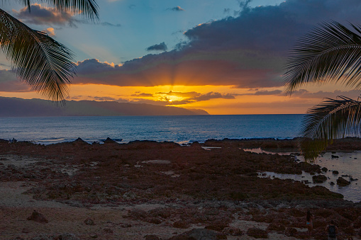 Sunset over Waimea Bay and Kaena Point on Oahu, Hawaii.