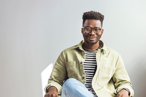 Smiling man wearing spectacles looking at camera. Portrait of black confident man at home. Successful entrepreneur feeling satisfied. Smiling african American millennial businessman in glasses