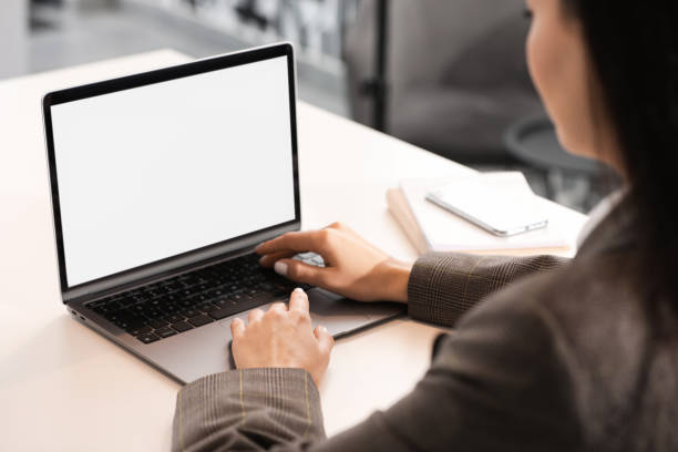istock Woman using modern laptop at desk in office, closeup 1903214364