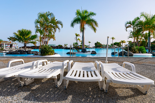 Sun loungers by the swimming pool in luxury hotel resort
