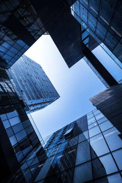 istock Low angle of tall corporate buildings skyscraper with reflection 1903221071