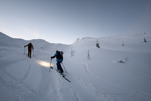 Ski touring in high mountain. Ascent to summit of peak. Snow and winter activities, skitouring in mountains.