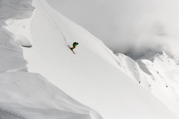 istock View from drone on man freerider riding down from top of ridge. 1903268678