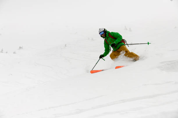 istock close-up view of active athlete riding down snow-covered mountain on splitboard 1903275851