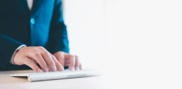 istock businessman Hands typing on the remote wireless computer keyboard in an office at a workplace isolated on a white background 1903282994