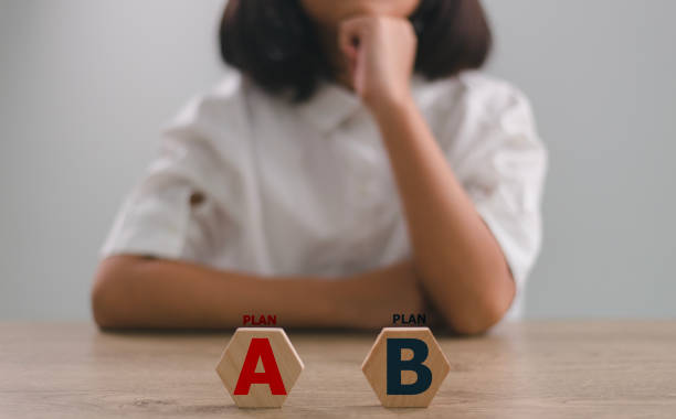 istock Women Checked PLAN A or B on wooden blocks with the words Plan A and B business plan concept. 1903413970