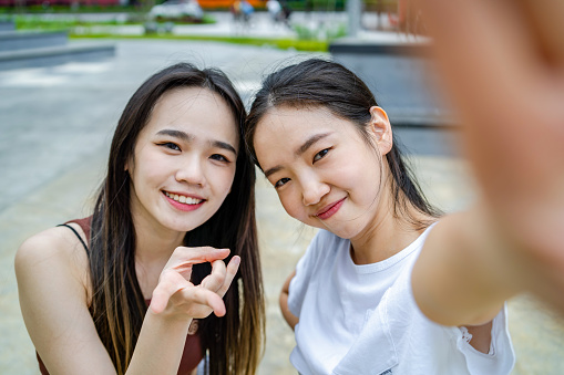 Close up photo of energetic students together taking selfie together  in urban city park, with copy space