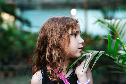 Little girl discovering the plant garden