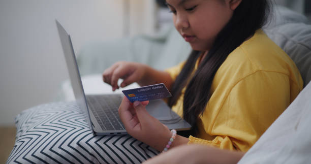 istock smart girl use credit card to payment online through laptop computer 1903530843