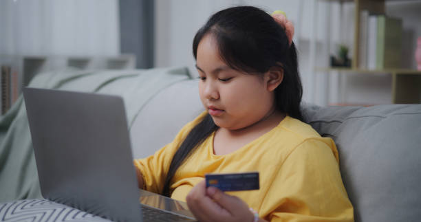 istock smart girl use credit card to payment online through laptop computer 1903530854