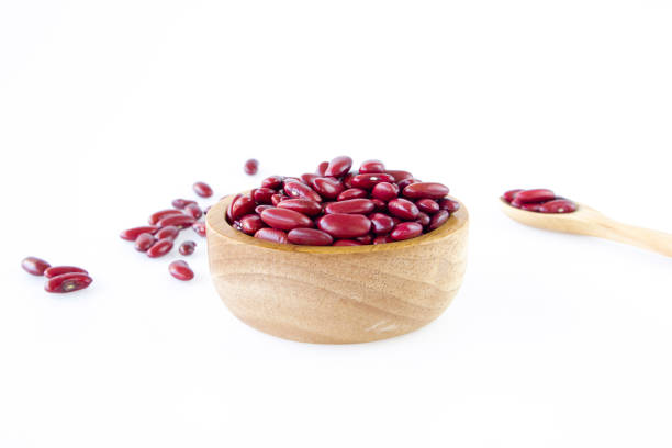 Red kidney beans in wooden bowl on white background, Food ingredient, Top view