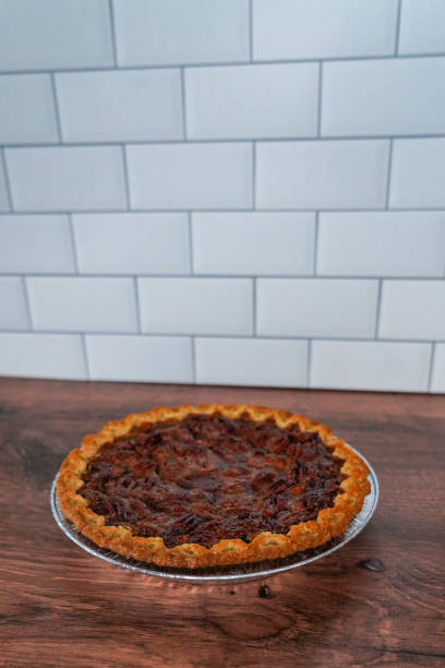 istock Pecan pie on a wooden counter against a tiled backsplash 1903575546