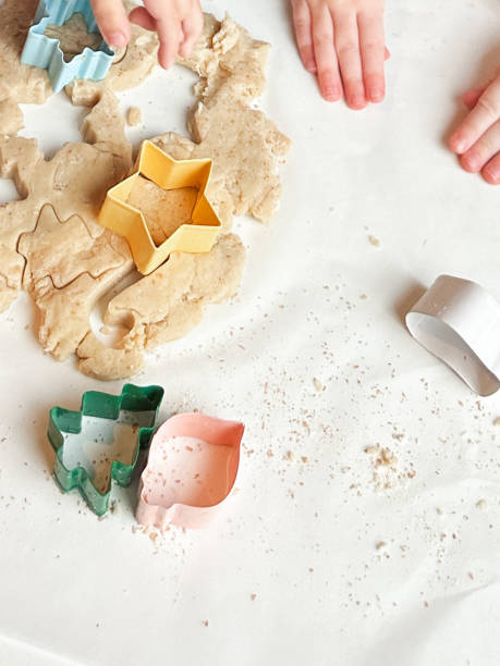 istock Child Hands with Cookie Dough and Cookie Cutters 1903595869