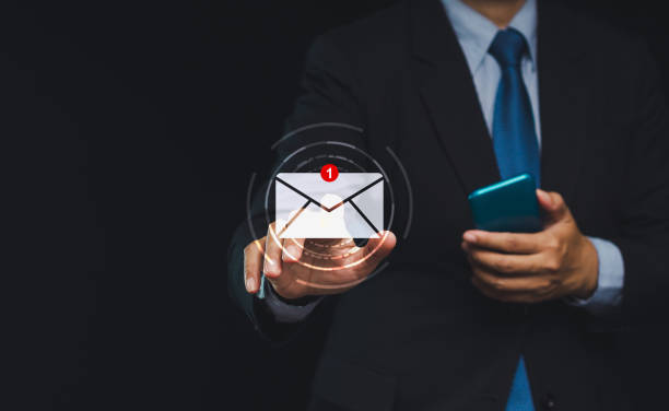 istock Businessman touching on a new email on a virtual screen while standing on a black background 1903596401