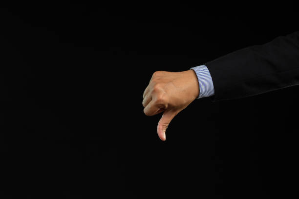 istock Negative concept. Close-up of hand showing a thumbs down for dislike service 1903601617
