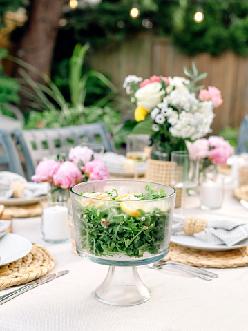 Beautiful summer tablescape with pink florals and a refreshing salad in Seattle, Washington, United States