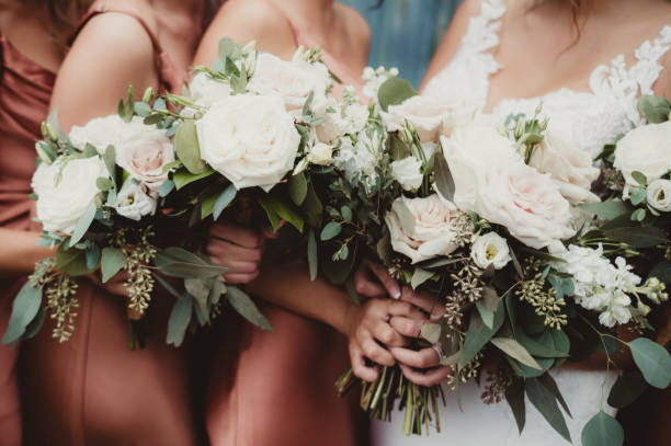 istock Close up of wedding bouquets held by bride and bridesmaids 1903616791