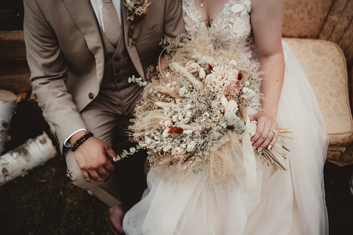 Boho wedding bouquet with bride and groom