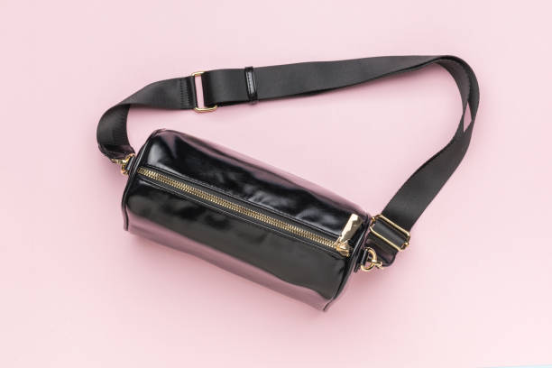istock A closed black leather bag on a pink background. 1903664249