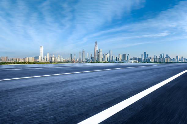 istock Empty asphalt road and city buildings skyline 1903675533