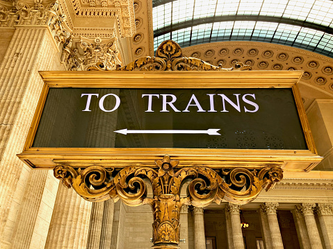 Chicago, Illinois, USA - July 23, 2020: A “To Trains” sign in the main hall of Union Station in downtown Chicago directs passengers to Amtrak and local commuter train platforms within the sprawling transportation hub.