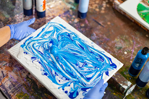 4K Happy Asian senior woman learning acrylic pouring art workshop with friends at art studio. Elderly retired woman enjoy and fun with colorful abstract modern art painting in classroom.