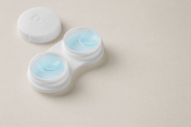 istock Contact lenses in white case with solution liquid on beige background 1903742523