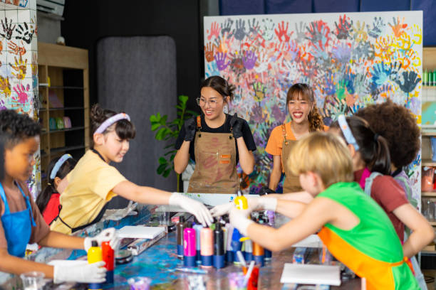 istock Group of Diversity school children learning acrylic art together in art class. 1903745581