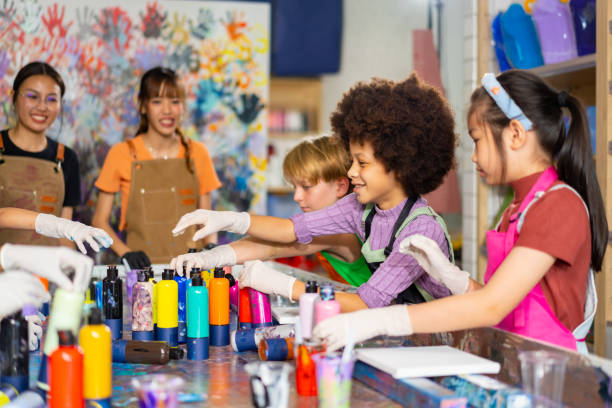 istock Group of Diversity school children learning acrylic art together in art class. 1903745590