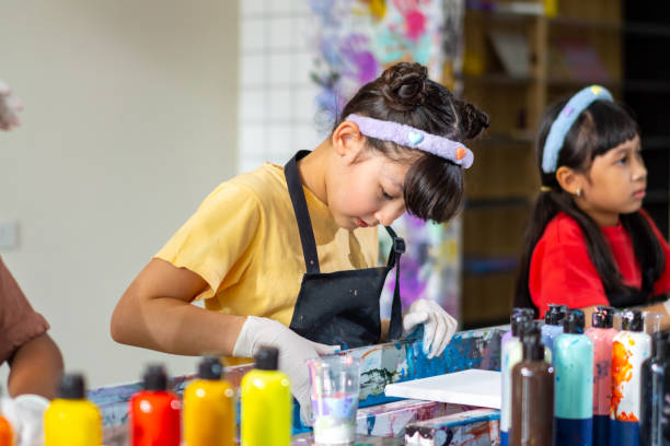 istock Group of Diversity school children learning acrylic art together in art class. 1903746108