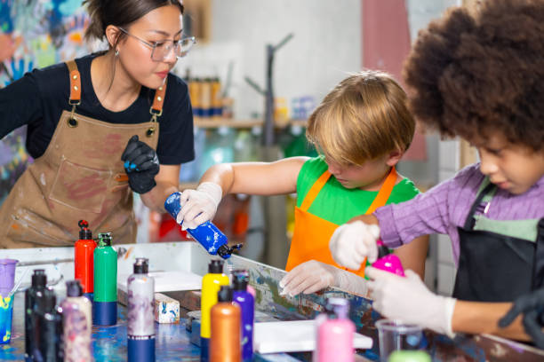 istock Group of Diversity school children learning acrylic art together in art class. 1903746110