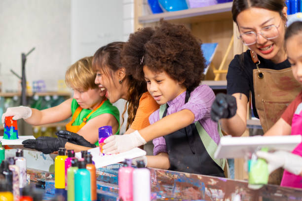istock Group of Diversity school children learning acrylic art together in art class. 1903747131