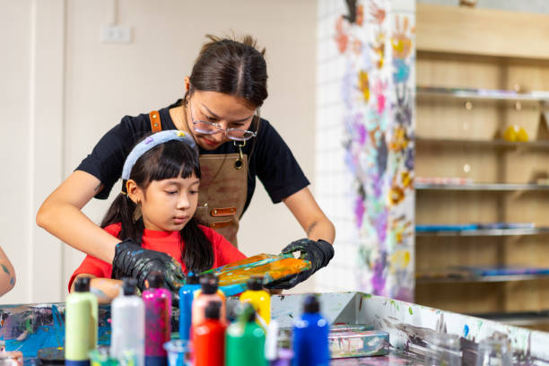 istock Group of Diversity school children learning acrylic art together in art class. 1903747656