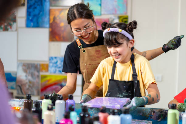 istock Group of Diversity school children learning acrylic art together in art class. 1903748162